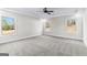 Bright bedroom featuring new carpet, a ceiling fan, and large windows at 279 Deer Creek Run # 4, Moreland, GA 30259
