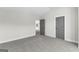 Bright bedroom featuring neutral walls, carpet flooring, and a gray door at 279 Deer Creek Run # 4, Moreland, GA 30259