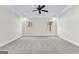 Bright bedroom featuring new carpet, a ceiling fan, and large windows at 279 Deer Creek Run # 4, Moreland, GA 30259