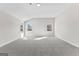This spacious bonus room has large windows, neutral paint, and soft carpet flooring at 279 Deer Creek Run # 4, Moreland, GA 30259