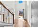 Bright foyer with hardwood floors, a staircase, and an open doorway revealing a picturesque outdoor view at 279 Deer Creek Run # 4, Moreland, GA 30259