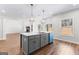 Modern kitchen with gray island featuring a sink, set against hardwood floors and an open floor plan at 279 Deer Creek Run # 4, Moreland, GA 30259