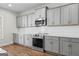 Modern kitchen featuring gray cabinets, stainless steel appliances, and a white tile backsplash at 279 Deer Creek Run # 4, Moreland, GA 30259