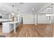 Bright kitchen area with modern pendant lights, a large island, and hardwood floors with open space at 279 Deer Creek Run # 4, Moreland, GA 30259