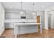 Modern kitchen with gray cabinets, stylish pendant lighting, and a large central island, creating an inviting space at 279 Deer Creek Run # 4, Moreland, GA 30259
