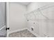 Small laundry room featuring practical shelving, tile flooring, and a minimalist design at 279 Deer Creek Run # 4, Moreland, GA 30259