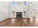 Bright and airy living room featuring hardwood floors, a brick fireplace, high ceilings, and abundant natural light at 279 Deer Creek Run # 4, Moreland, GA 30259