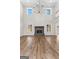 Expansive living area with hardwood floors, a striking fireplace, large windows, and an open, airy atmosphere at 279 Deer Creek Run # 4, Moreland, GA 30259