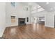 Spacious living room with soaring ceilings, hardwood floors, a brick fireplace, and an open view to the kitchen at 279 Deer Creek Run # 4, Moreland, GA 30259