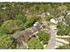 An aerial view shows lovely townhomes situated in a densely wooded neighborhood at 5599 Fair Creek Way, Lithonia, GA 30038