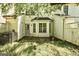 Backyard featuring a grassy lawn, patio, foliage, and a bay window at 5599 Fair Creek Way, Lithonia, GA 30038