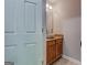 Powder room features a vessel sink, granite countertop, and warm wood cabinetry at 5599 Fair Creek Way, Lithonia, GA 30038