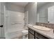 Bathroom featuring a granite countertop, tile floors, and tiled tub and shower surround at 5599 Fair Creek Way, Lithonia, GA 30038