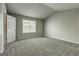 Spacious bedroom with neutral carpet, vaulted ceiling, and natural light from the window at 5599 Fair Creek Way, Lithonia, GA 30038