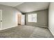 A carpeted bedroom with vaulted ceiling and windows, as well as a doorway to a closet at 5599 Fair Creek Way, Lithonia, GA 30038