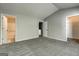 A carpeted bedroom with an ensuite bathroom and closet space is viewed from the doorway at 5599 Fair Creek Way, Lithonia, GA 30038