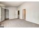 Neutral bedroom with neutral walls, carpet, and doors leading to closets at 5599 Fair Creek Way, Lithonia, GA 30038