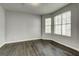 Neutral bedroom with hard wood floors, neutral paint and large windows at 5599 Fair Creek Way, Lithonia, GA 30038
