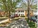 Exterior view of townhomes featuring matching shutters and driveways at 5599 Fair Creek Way, Lithonia, GA 30038