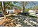 Neighborhood street view, showcasing a well-maintained townhome exterior and mature trees at 5599 Fair Creek Way, Lithonia, GA 30038