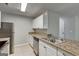 Kitchen featuring granite countertops, stainless steel appliances, and white cabinetry at 5599 Fair Creek Way, Lithonia, GA 30038