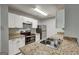 Kitchen featuring granite countertops, stainless steel appliances, and white cabinetry at 5599 Fair Creek Way, Lithonia, GA 30038