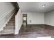Spacious living room featuring hardwood floors and a staircase at 5599 Fair Creek Way, Lithonia, GA 30038