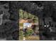 Aerial view of a house situated on a well-defined lot surrounded by mature trees and neighboring houses at 1190 N Ola Rd, Mcdonough, GA 30252