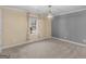 This bedroom features neutral carpet, a bright window with curtains, and neutral paint at 1190 N Ola Rd, Mcdonough, GA 30252