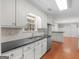 Spacious kitchen features white cabinets, stainless steel appliances, stone countertops, and hardwood floors at 1190 N Ola Rd, Mcdonough, GA 30252