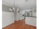 Open-concept kitchen featuring white cabinets, black countertops, stainless steel appliances, and hardwood floors at 1190 N Ola Rd, Mcdonough, GA 30252