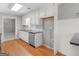 Kitchen featuring white cabinets, stainless steel appliances, black countertops, and hardwood floors at 1190 N Ola Rd, Mcdonough, GA 30252