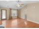 Bright living room featuring hardwood floors, a ceiling fan, and large windows offering lots of natural light at 1190 N Ola Rd, Mcdonough, GA 30252