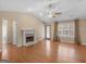 Spacious living room boasting a fireplace, hardwood floors, large windows, and a ceiling fan at 1190 N Ola Rd, Mcdonough, GA 30252