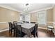 Elegant dining room with modern lighting, hardwood floors, and large windows at 4435 Ross Estates Ct, Snellville, GA 30039