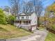 Charming two-story home with a brick foundation, inviting front porch, and well-maintained landscaping at 4435 Ross Estates Ct, Snellville, GA 30039