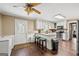 Bright kitchen with an island, white cabinets, stainless steel appliances, and hardwood floors at 4435 Ross Estates Ct, Snellville, GA 30039
