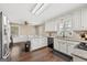 Spacious eat-in kitchen featuring white cabinetry, granite countertops, and stainless steel appliances at 4435 Ross Estates Ct, Snellville, GA 30039