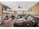 Comfortable living room with a brick fireplace, hardwood floors, and a large sectional sofa at 4435 Ross Estates Ct, Snellville, GA 30039