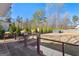 Backyard deck overlooking a lush green lawn, mature trees, and a storage shed at 90 Hazelridge Ln, Sharpsburg, GA 30277