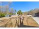 Large backyard featuring well-maintained lawn, storage shed, and a patio seating area at 90 Hazelridge Ln, Sharpsburg, GA 30277
