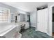 Bright bathroom featuring a separate soaking tub, vanity, and tiled floor at 90 Hazelridge Ln, Sharpsburg, GA 30277