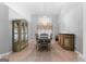Dining room with a large window, elegant chandelier, and matching wooden furniture for a sophisticated look at 90 Hazelridge Ln, Sharpsburg, GA 30277