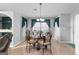 The dining room showcases tile flooring, a chandelier, and a glass table with seating for four at 90 Hazelridge Ln, Sharpsburg, GA 30277
