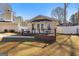 Exterior view of a charming home addition with a small deck and outdoor seating at 90 Hazelridge Ln, Sharpsburg, GA 30277