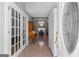 Inviting foyer view with white trim, glass french doors, chandelier, and an arched entryway to the dining area at 90 Hazelridge Ln, Sharpsburg, GA 30277