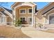 Inviting front porch showcases a path with decorative palms, columns, seating, and a charming front door at 90 Hazelridge Ln, Sharpsburg, GA 30277