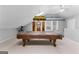 Well-lit game room featuring a pool table, skylights, and a ceiling fan at 90 Hazelridge Ln, Sharpsburg, GA 30277