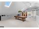 Spacious game room with pool table, natural light from skylights, and ceiling fan at 90 Hazelridge Ln, Sharpsburg, GA 30277