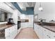 Bright kitchen features white cabinets, granite countertops, stainless steel appliances, and tile floors at 90 Hazelridge Ln, Sharpsburg, GA 30277